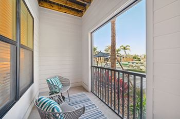 A balcony with a chair and a pillow at The Concord Luxury Apartments, Florida, 34240
